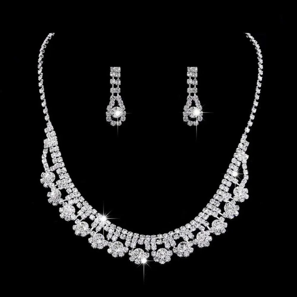 A sparkling silver rhinestone zircon water drop necklace with floral design and matching drop earrings set