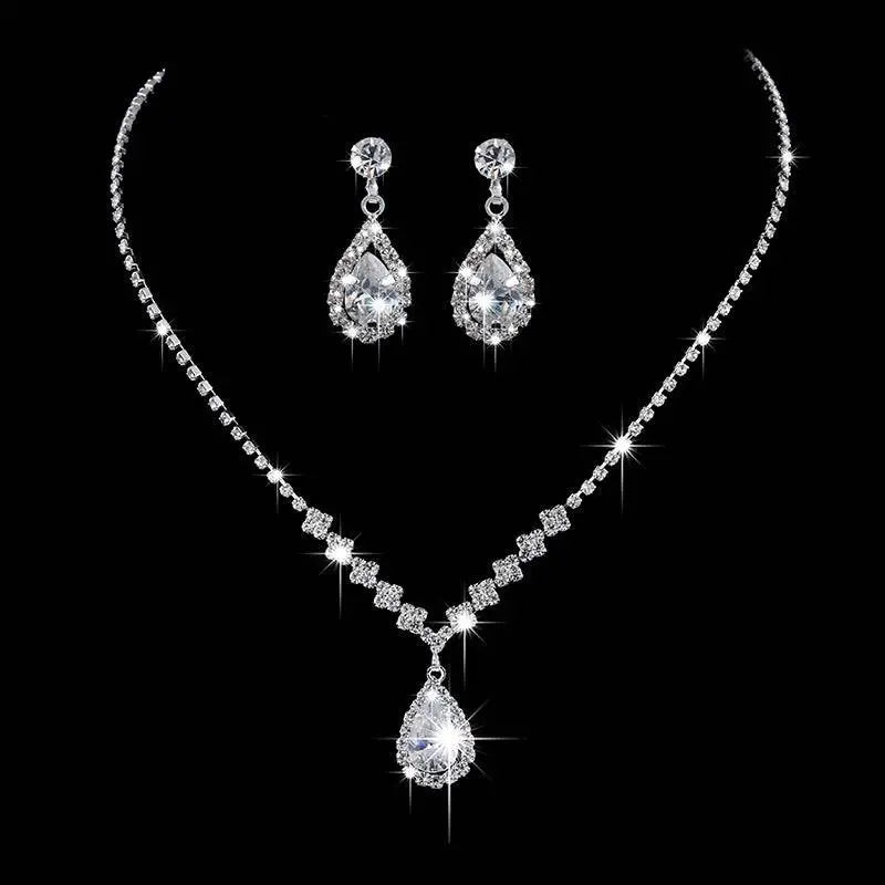 A sparkling silver rhinestone zircon water drop necklace and matching drop earrings set adorned with clear crystals