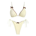 Cream-colored ribbed bikini set with brown bow accents on straps and center perfect for beige swimwear trends