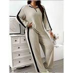 Beige ribbed knit two-piece loungewear set featuring ribbed knit striped black side stripes and wide leg pants
