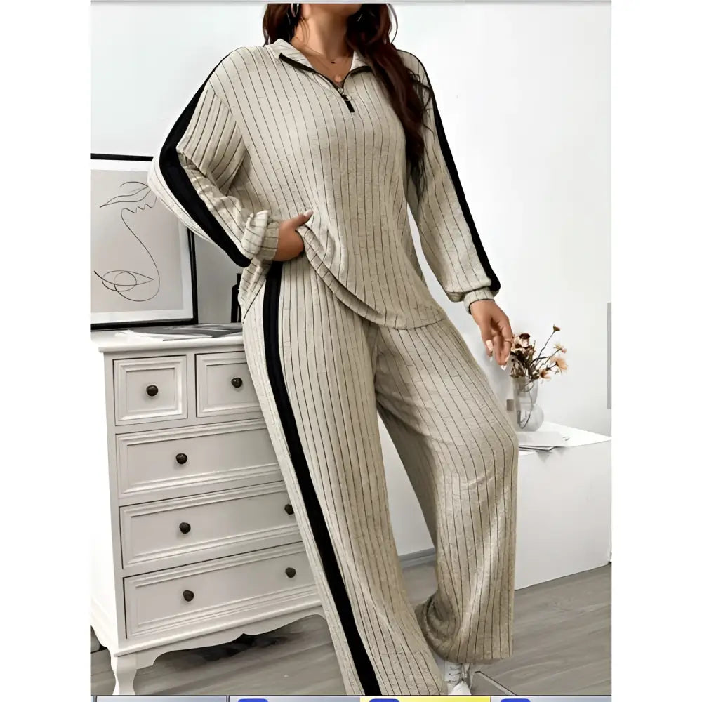 Beige ribbed knit two-piece loungewear set featuring ribbed knit striped black side stripes and wide leg pants
