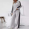 Gray ribbed knit pajama set with black side panels and quarter-zip collar featuring wide leg pants design