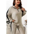 Beige ribbed knit two-piece loungewear set with ribbed knit striped wide leg pants and black side panels with half-zip collar