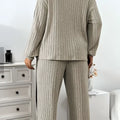 Beige ribbed knit two-piece loungewear set featuring wide leg pants and ribbed knit striped detailing