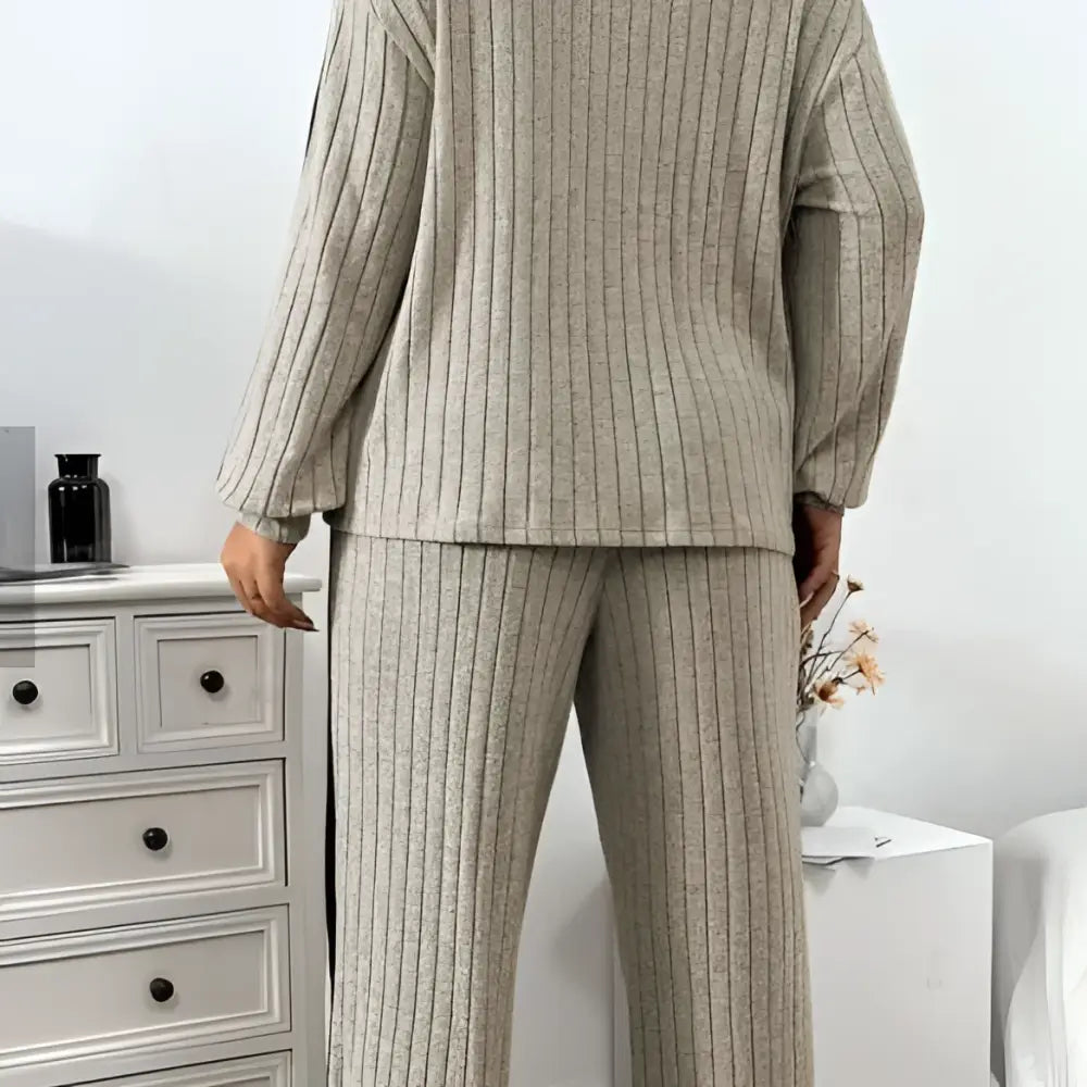 Beige ribbed knit two-piece loungewear set featuring wide leg pants and ribbed knit striped detailing