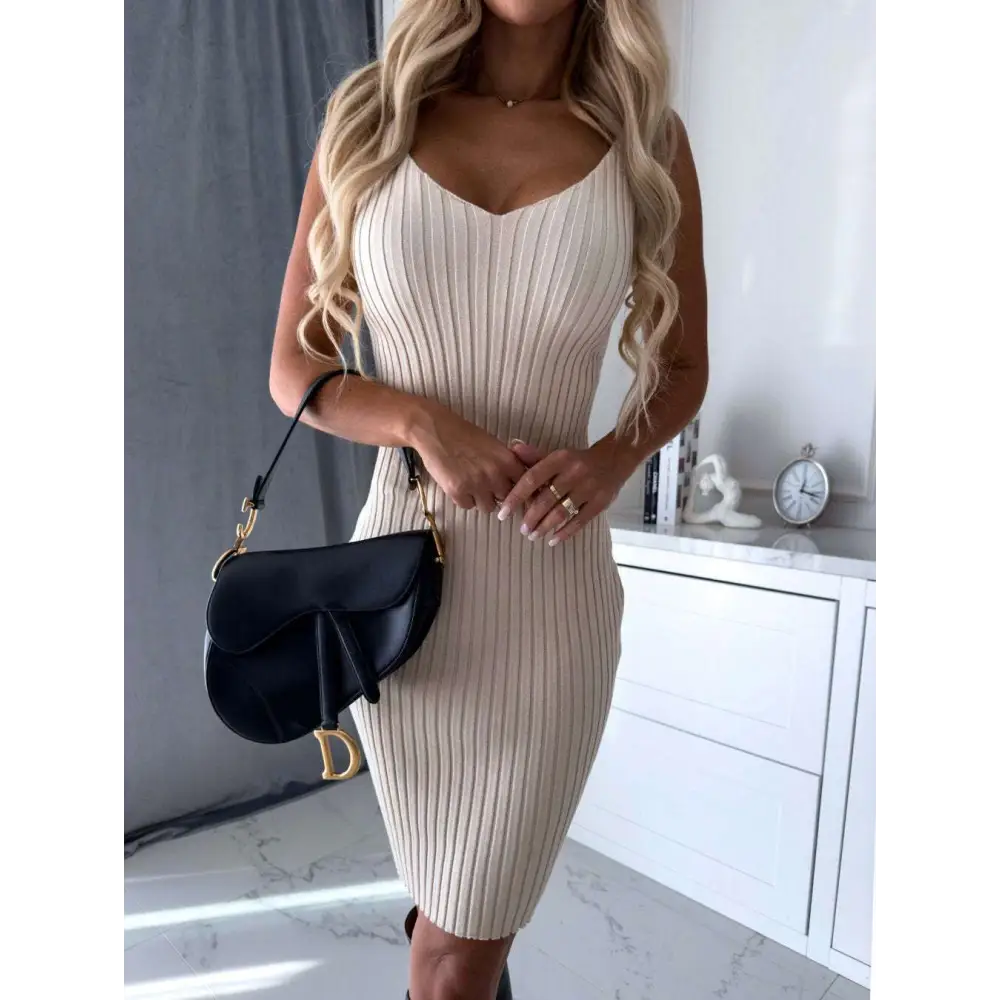 Black leather Dior saddle bag with gold-tone hardware paired with ribbed knit sleeveless top and tight suspender skirt fashion autumn