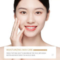 A woman with radiant skin gently touches her cheek using rice skin rejuvenation skincare set with essence milk and eye cream
