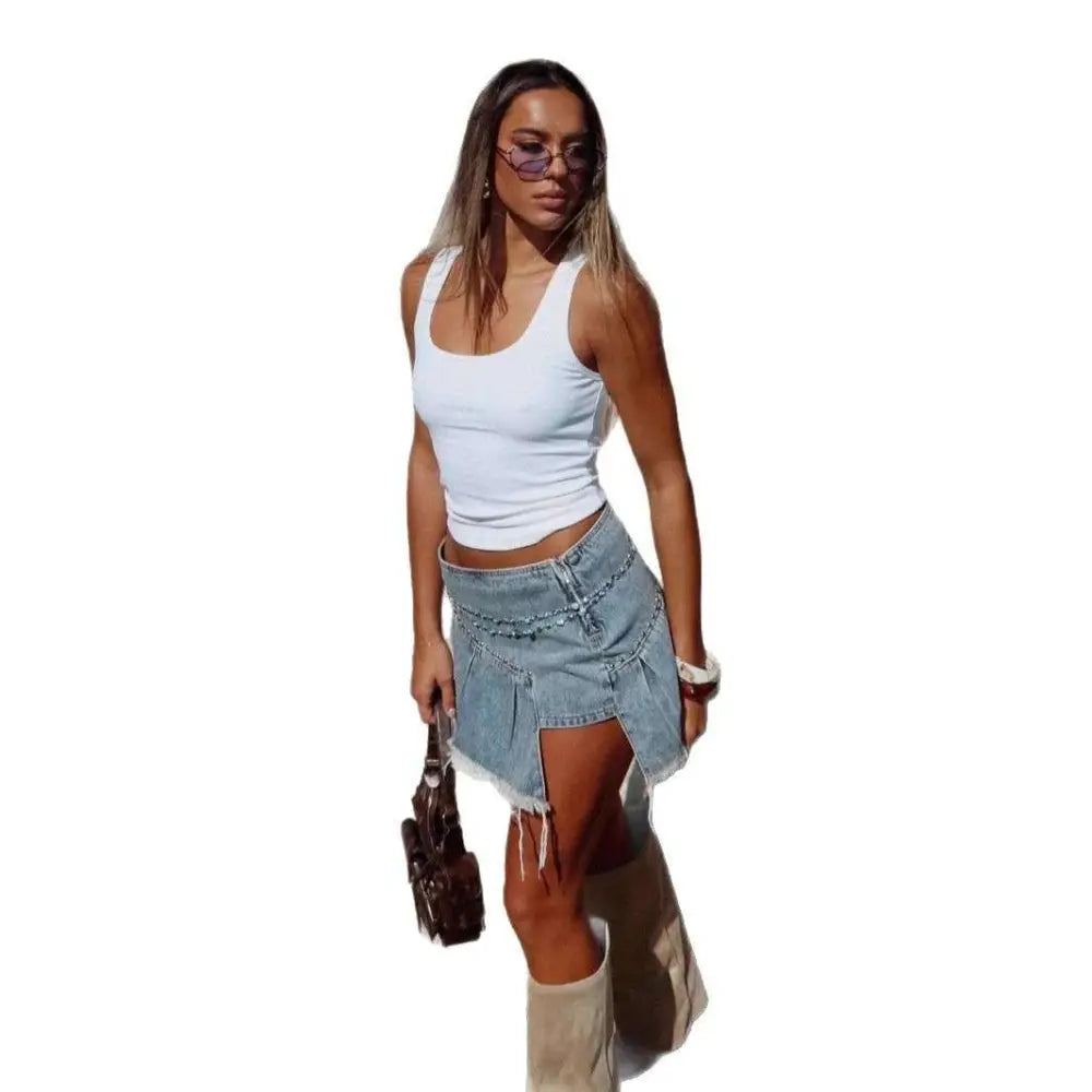 A light blue denim skirt with an irregular pleated design, frayed hem, and side slit for a stylish look