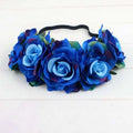 A blue floral rose headband with layered fabric roses and green leaves from the rose color package