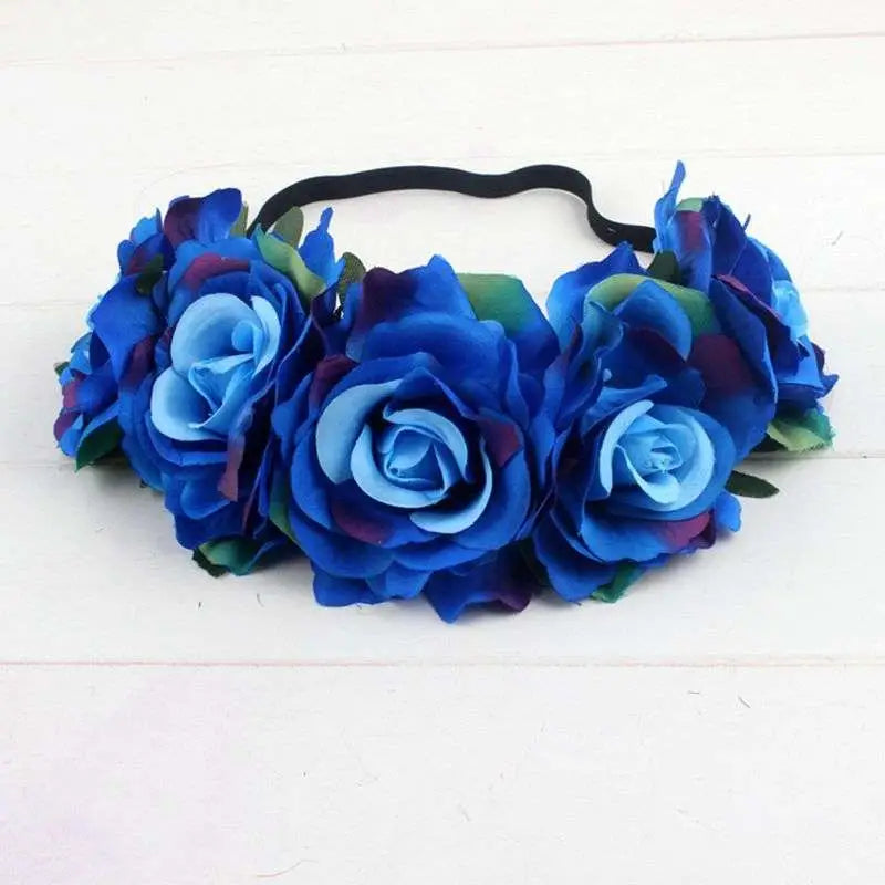 A blue floral rose headband with layered fabric roses and green leaves from the rose color package