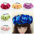 A blue floral rose headband with layered fabric roses and green leaves in the rose color package design