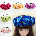 A blue floral rose headband with layered fabric roses green accents and a black elastic band from rose color package