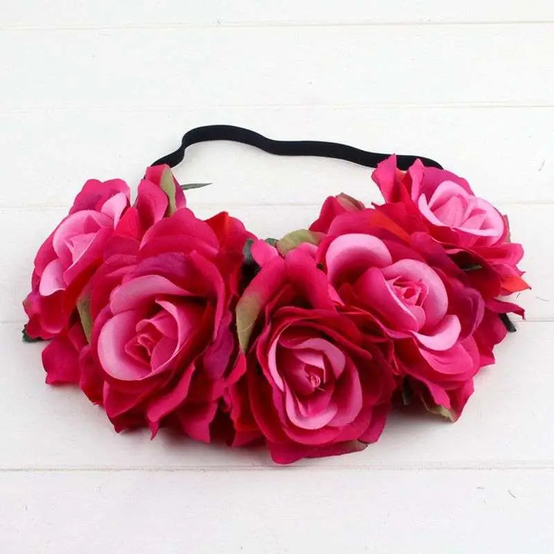 A vibrant pink floral rose headband with artificial roses green leaves and black elastic band in rose color package