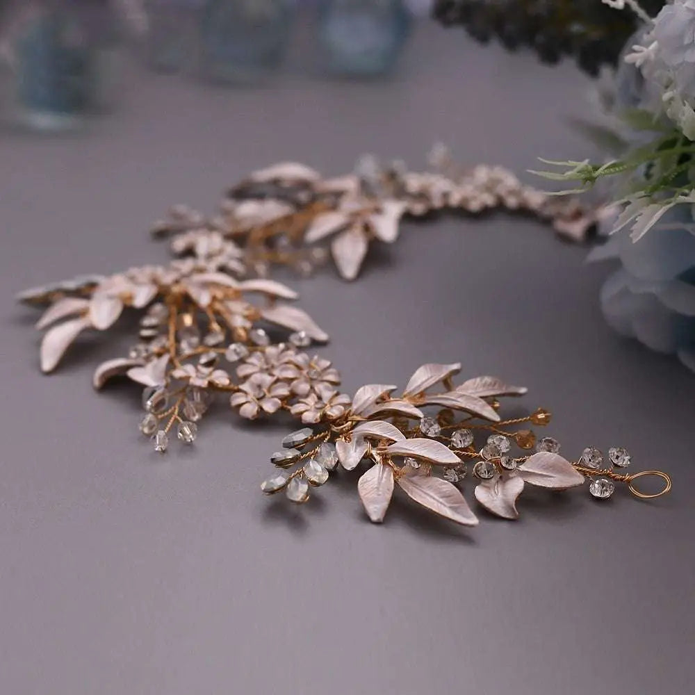 A delicate rose gold floral hair accessory with alloy crystals japan featuring lace-like leaves and sparkling crystals