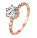 Rose gold beaded sterling silver ring with a round gemstone and an ornate twisted band design in sterling silver