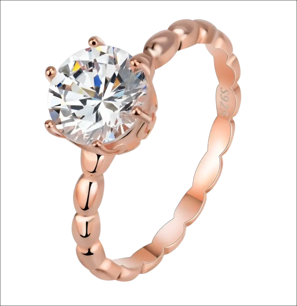 Rose gold beaded sterling silver ring with a round-cut gemstone and an ornate twisted band design sterling silver ring