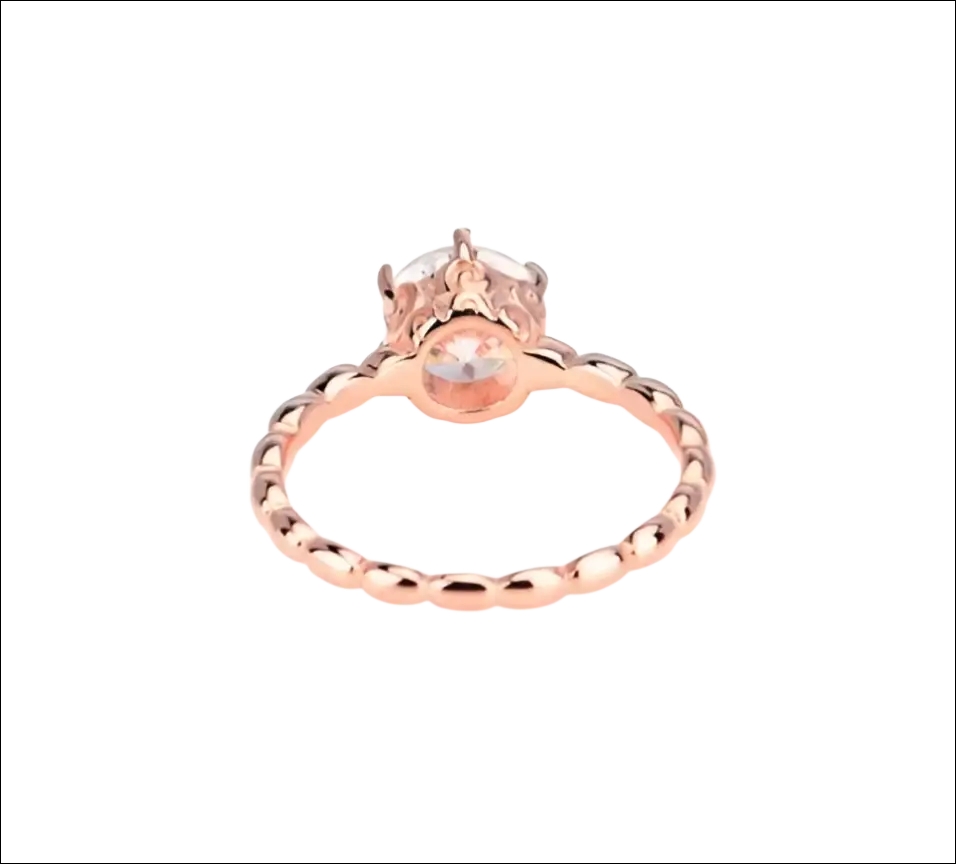 Rose gold beaded sterling silver ring with a central round-cut gemstone set in an ornate silver band