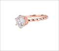 Rose gold beaded sterling silver ring with a twisted band and round prong-set clear gemstone silver ring
