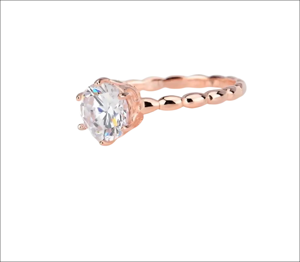 Rose gold beaded sterling silver ring with a twisted band and round prong-set clear gemstone silver ring