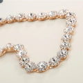 A rose gold bridal rhinestone sunflower hair band with clear crystal clusters set in intricate metalwork