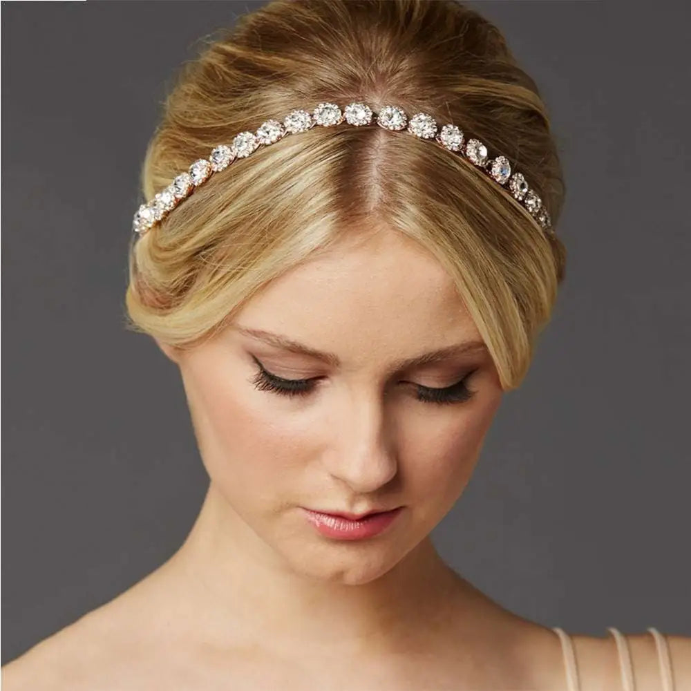 A delicate rose gold bridal rhinestone sunflower hair band adorned with clear sparkling crystals for weddings