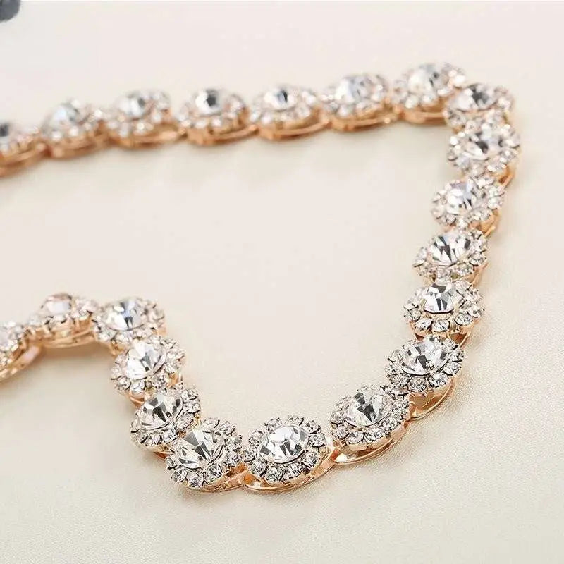A sparkling rose gold bridal rhinestone sunflower hair band with large clear crystal clusters and intricate metalwork