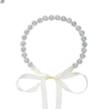 Delicate silver beaded bridal rhinestone sunflower hair band with soft white satin bow for elegant bridal wear