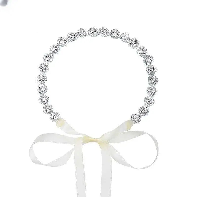 Delicate silver beaded bridal rhinestone sunflower hair band with soft white satin bow for elegant bridal wear