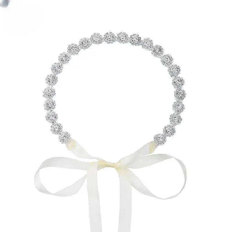 Delicate silver beaded sunflower hair band with soft white satin bow for gold bridal rhinestone styling