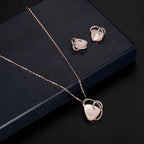 Rose gold heart pendant necklace with pink stone and diamond accents complementing pink jade earrings set