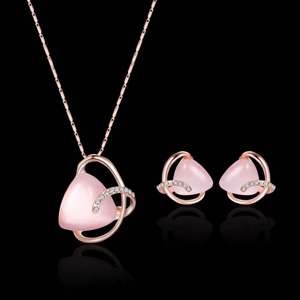 Rose gold heart pendant necklace with pink opal stone and diamond accents in a gold heart pink jewelry set