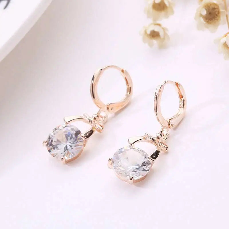 Rose gold crystal earrings with gold-plated butterfly pendant featuring delicate bow design for bride necklace set