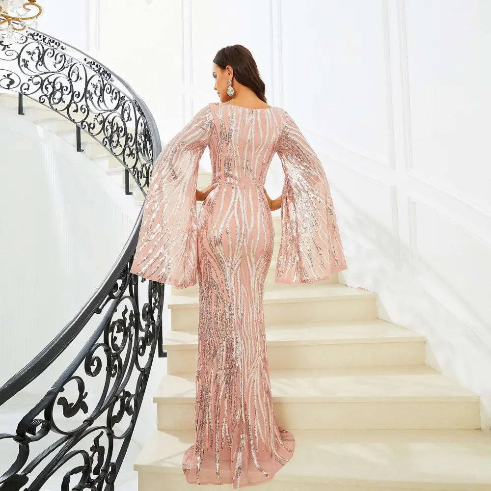 A rose gold long sleeve banquet sequined fishtail dress with shimmering sequins and flowing bell sleeves