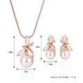 Rose gold pearl necklace earrings bridal set with delicate leaf-like metalwork surrounding white pearls