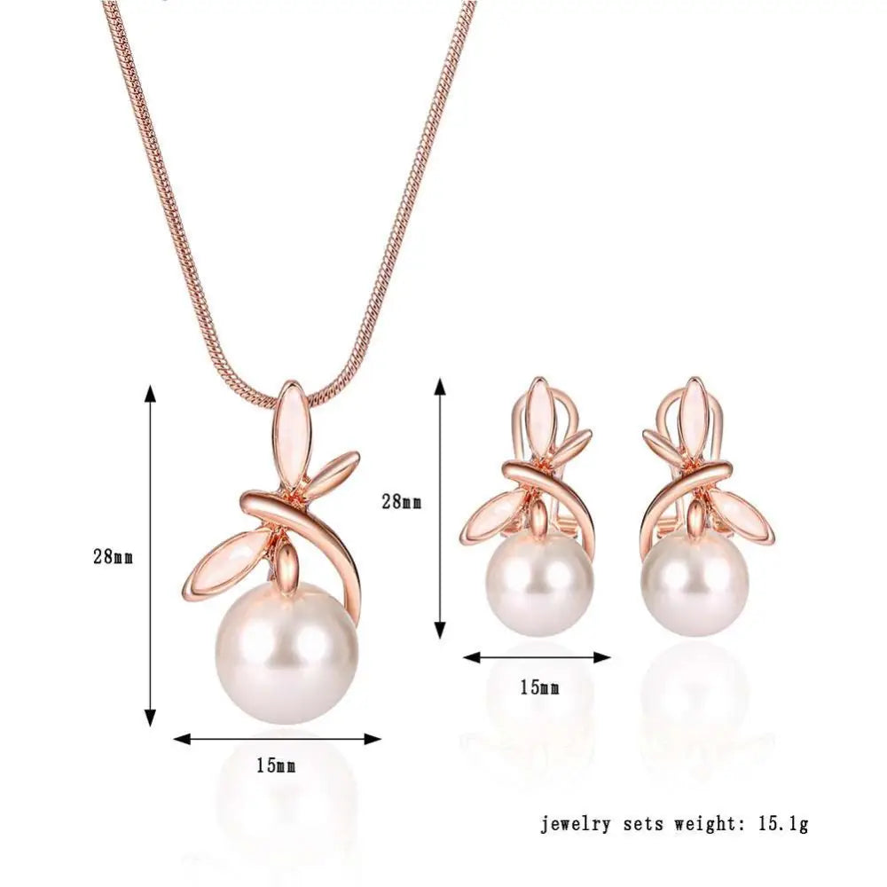 Rose gold pearl necklace earrings bridal set with delicate leaf-like metalwork surrounding white pearls