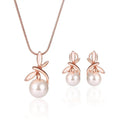 Rose gold pearl necklace earrings bridal set with delicate chain and stud earrings featuring lustrous white pearls and leaf motifs