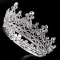 An ornate silver tiara with intricate floral designs and clear crystals for big european princess crown hair use