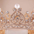A sparkling rose gold rhinestone big european princess crown hair tiara with intricate filigree and a large central diamond