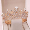 A sparkling rose gold rhinestone big European princess crown hair tiara with intricate filigree and clear crystals
