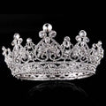 A sparkling silver big european princess crown hair tiara with intricate floral designs and clear crystals in rose gold rhinestone style