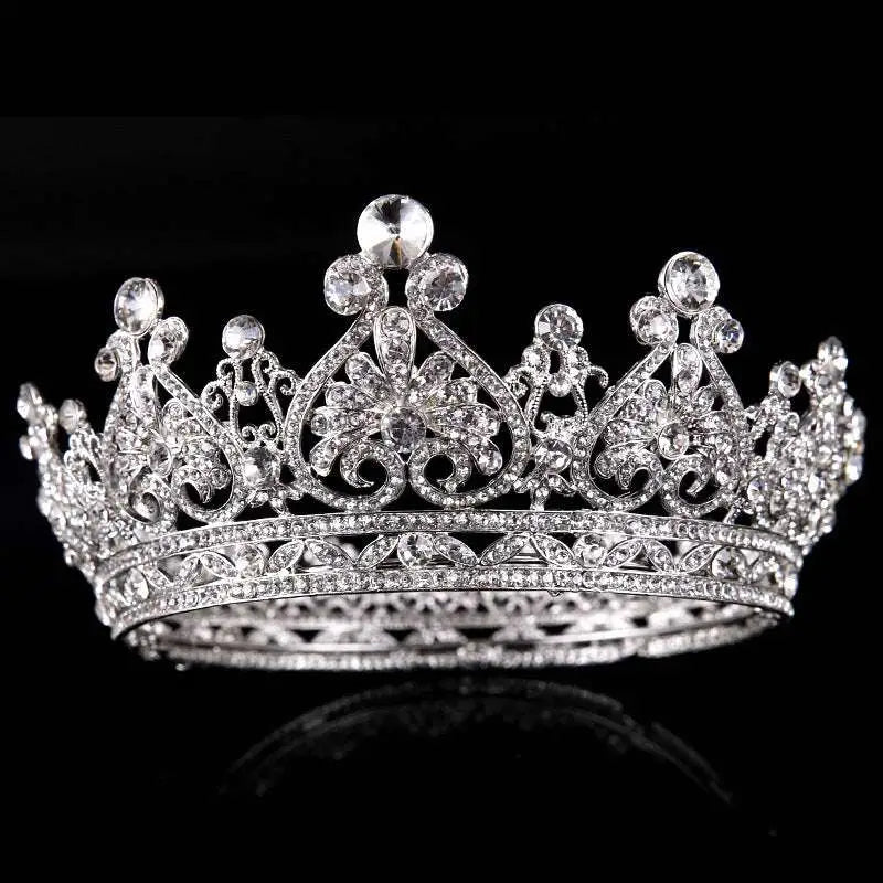 A sparkling silver big european princess crown hair tiara with intricate floral designs and clear crystals in rose gold rhinestone style