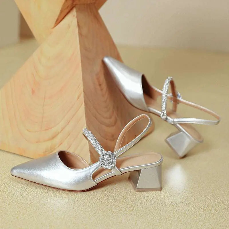 Silver metallic pointed-toe slingback heels with rhinestone ankle strap and block chunky heel complement rose gold satin style