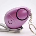 Rose gold egg-shaped security alarm keychain with led light, wrist strap, and personal security alarm features