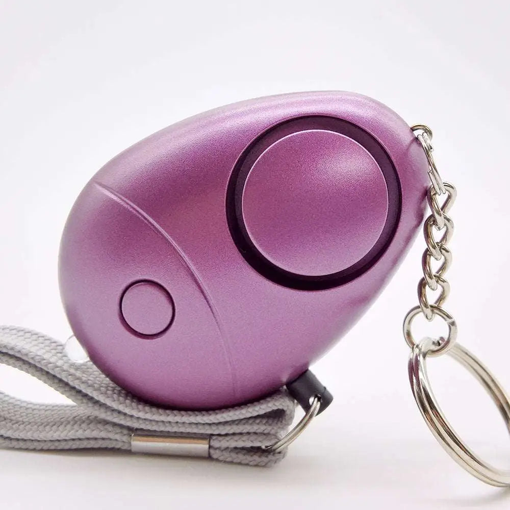 Rose gold egg-shaped security alarm keychain with led light, wrist strap, and personal security alarm features