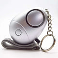 Silver emergency whistle with keychain and wrist strap as a personal security alarm for safety and convenience