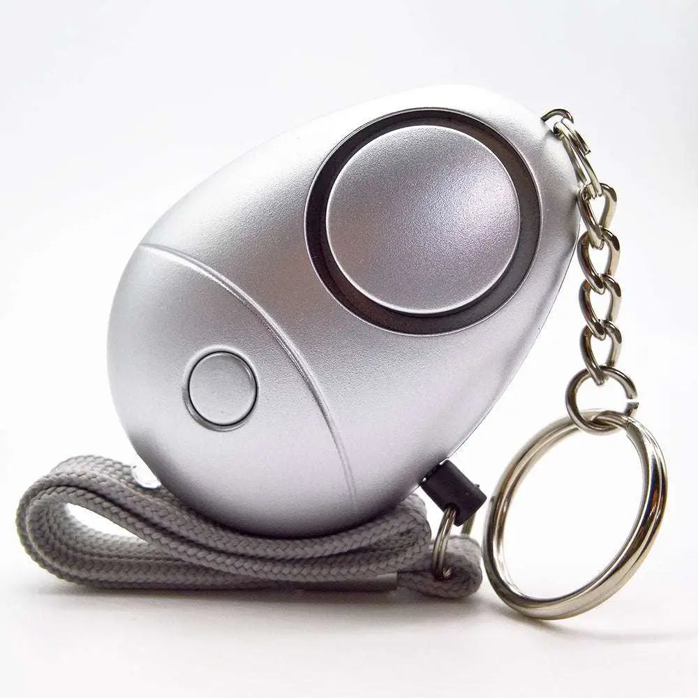 Silver emergency whistle with keychain and wrist strap as a personal security alarm for safety and convenience