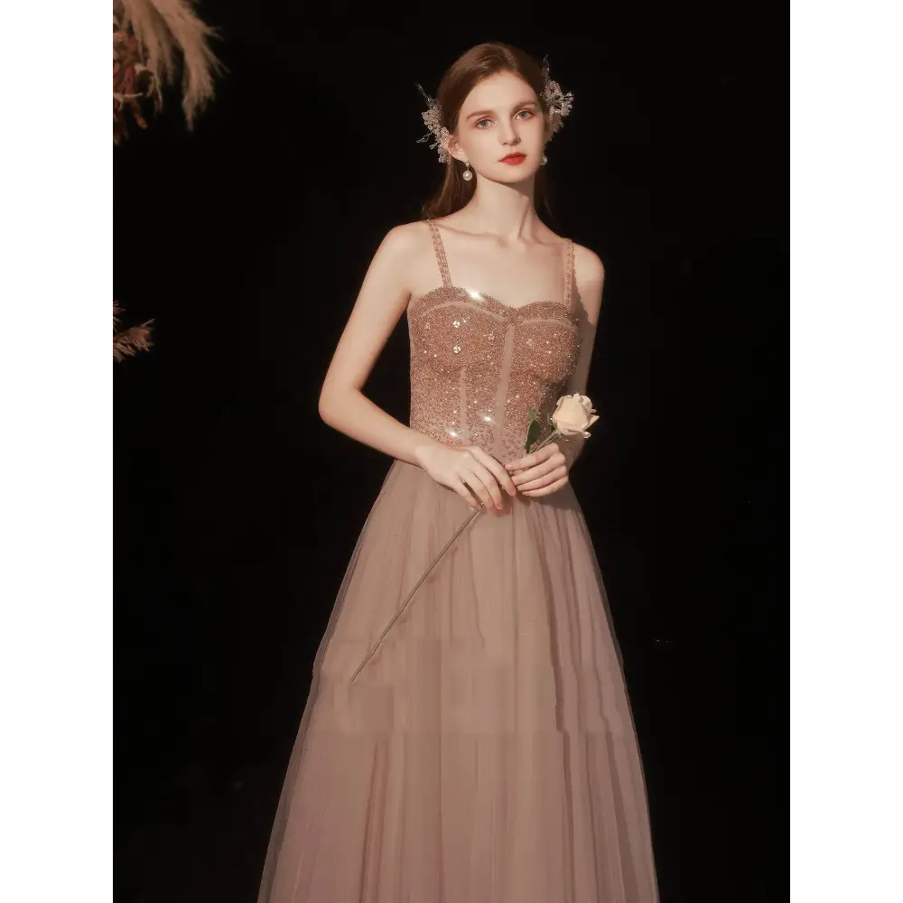 Rose gold sequin golden suspender dress female dinner features a shimmering bodice with sheer mesh and blush tulle skirt