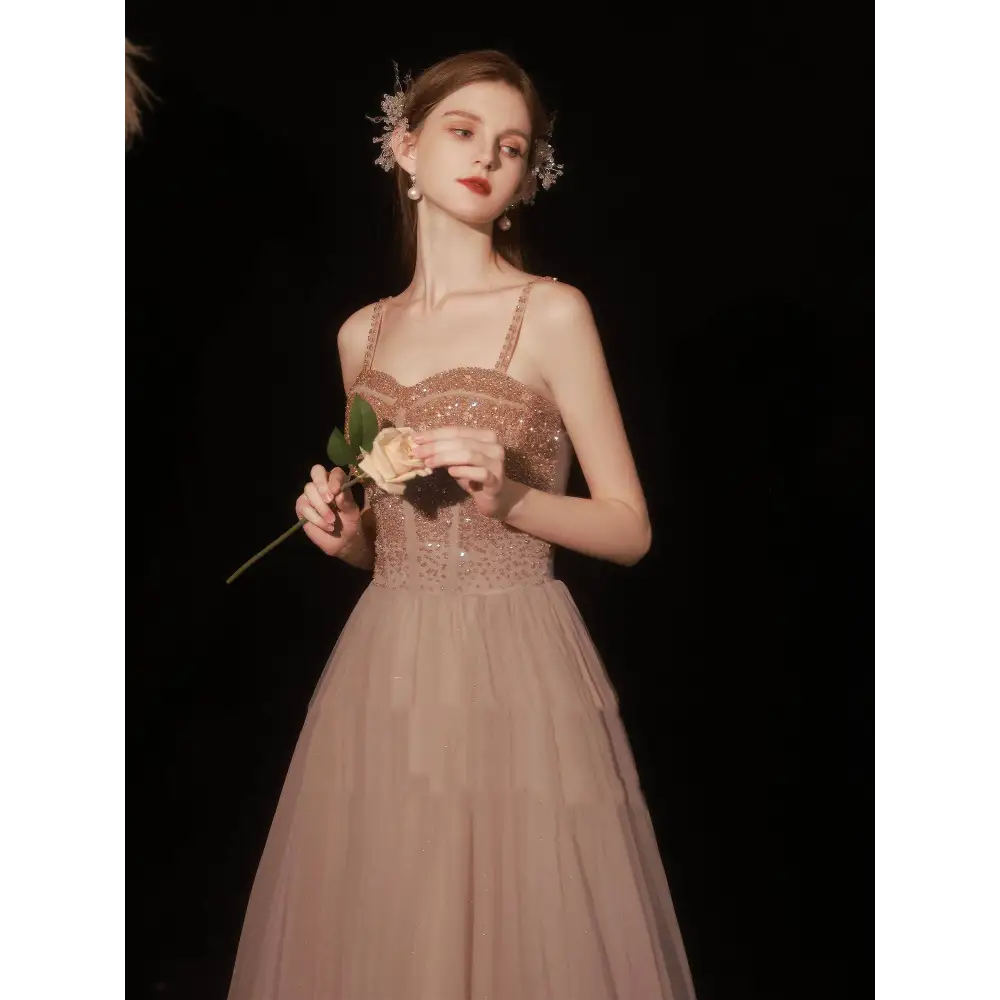 A blush pink rose gold sequin golden suspender dress female dinner gown with a sparkling beaded bodice and tulle skirt