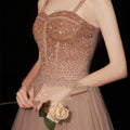 Rose gold sequin golden suspender dress female dinner features a shimmering bodice with sheer mesh and blush tulle skirt