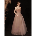 A rose gold sequin golden suspender dress female dinner featuring a shimmering bodice and flowing champagne tulle skirt